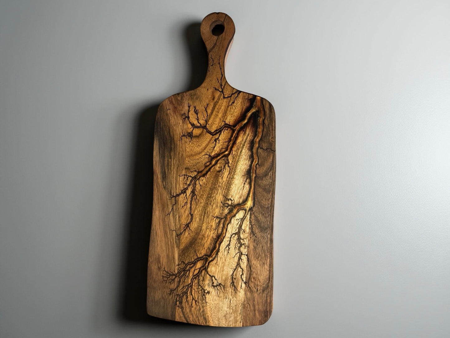 Acacia paddle charcuterie board featuring copper resin river flowing through fractal burned timber, artisan serving board Australia, Fractal Flow Designs