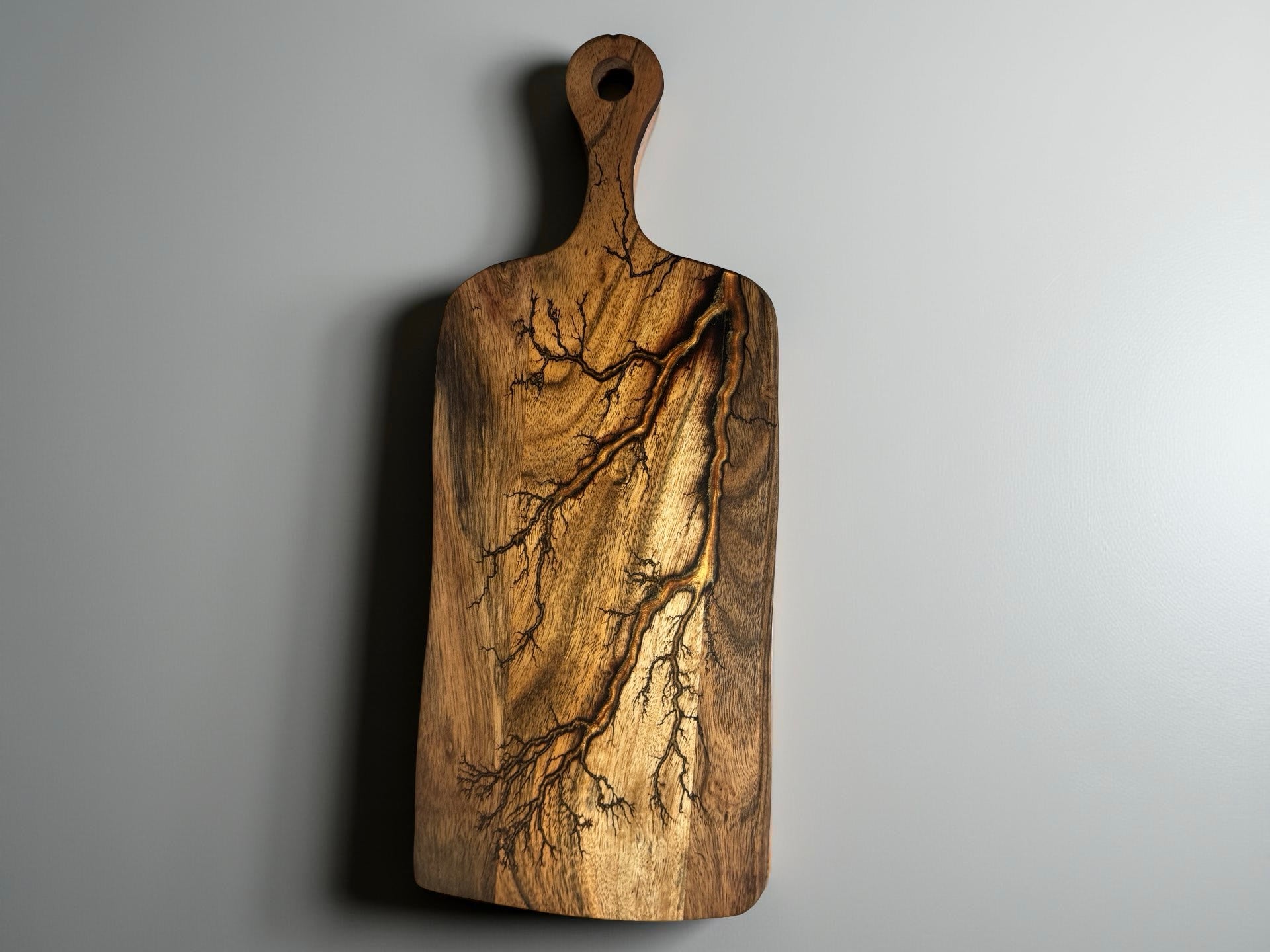 Acacia paddle charcuterie board featuring copper resin river flowing through fractal burned timber, artisan serving board Australia, Fractal Flow Designs