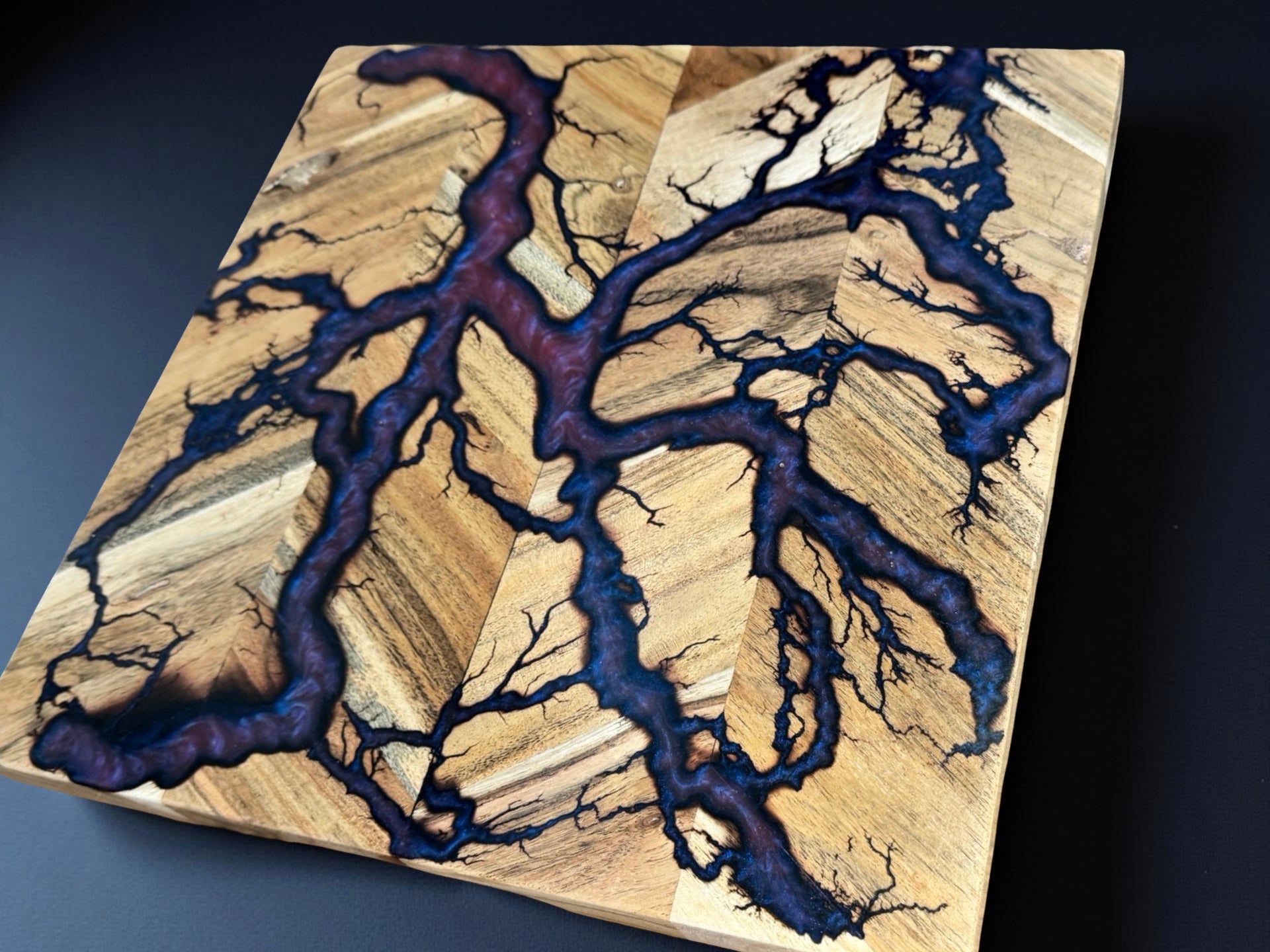 Australian resin chopping board 320 x 320 crafted in Bairnsdale showing shifting red green chameleon colours blended with dramatic fractal burning lines produced by Fractal Flow Designs Australia’s resin board brand from native timber