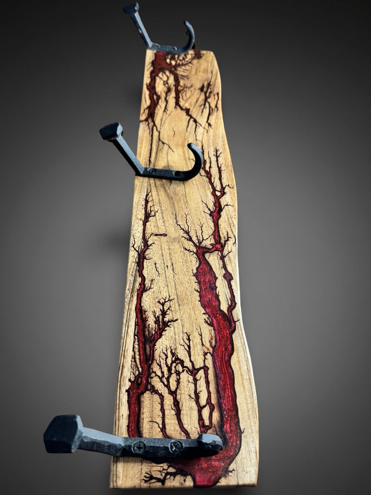 Red resin coat rack with chameleon sheen, bold Australian resin timber décor