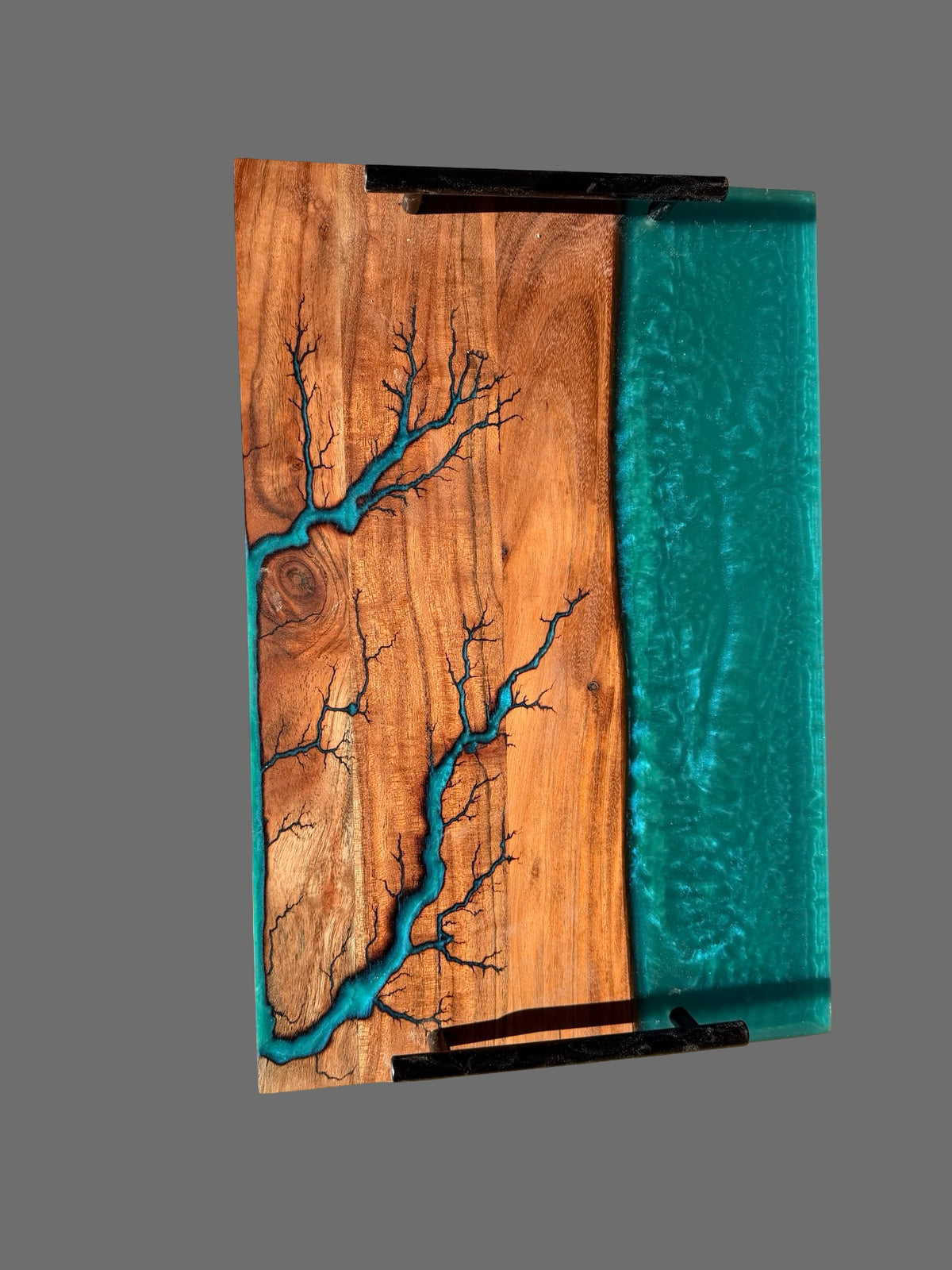 Perfect housewarming gift resin board featuring a turquoise blue resin river pattern and a solid turquoise section and black metal handles made by fractal flow designs, Australia