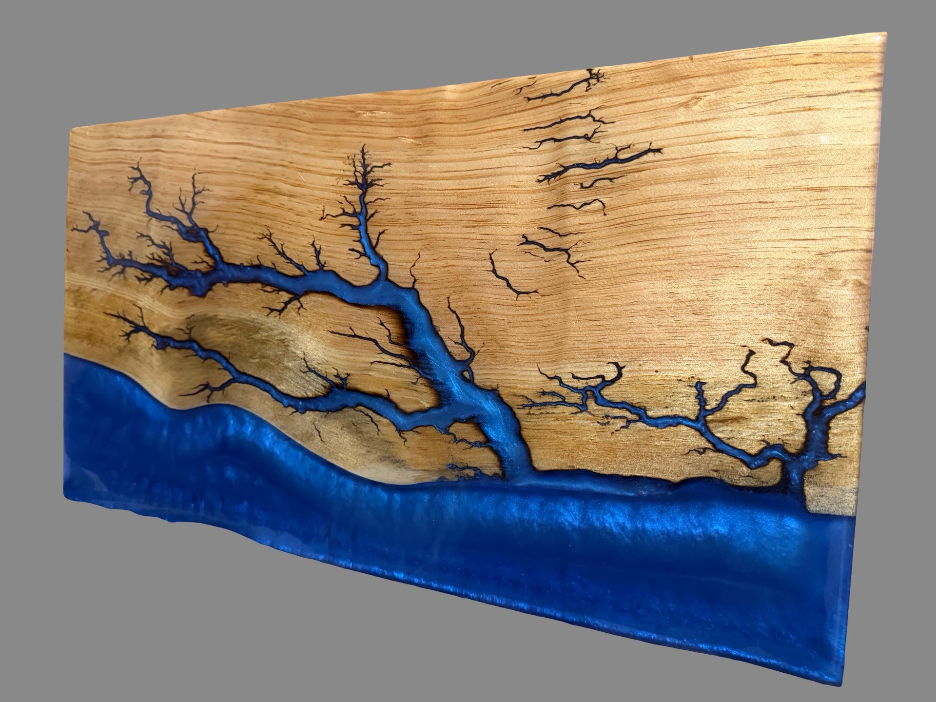     Large handcrafted timber serving board featuring electric blue resin art and signature fractal burning creating dramatic lightning-like patterns through the wood, 580 x 300 x 30mm, Australian made, food-contact safe finish, ideal for charcuterie, cheese boards and premium home décor