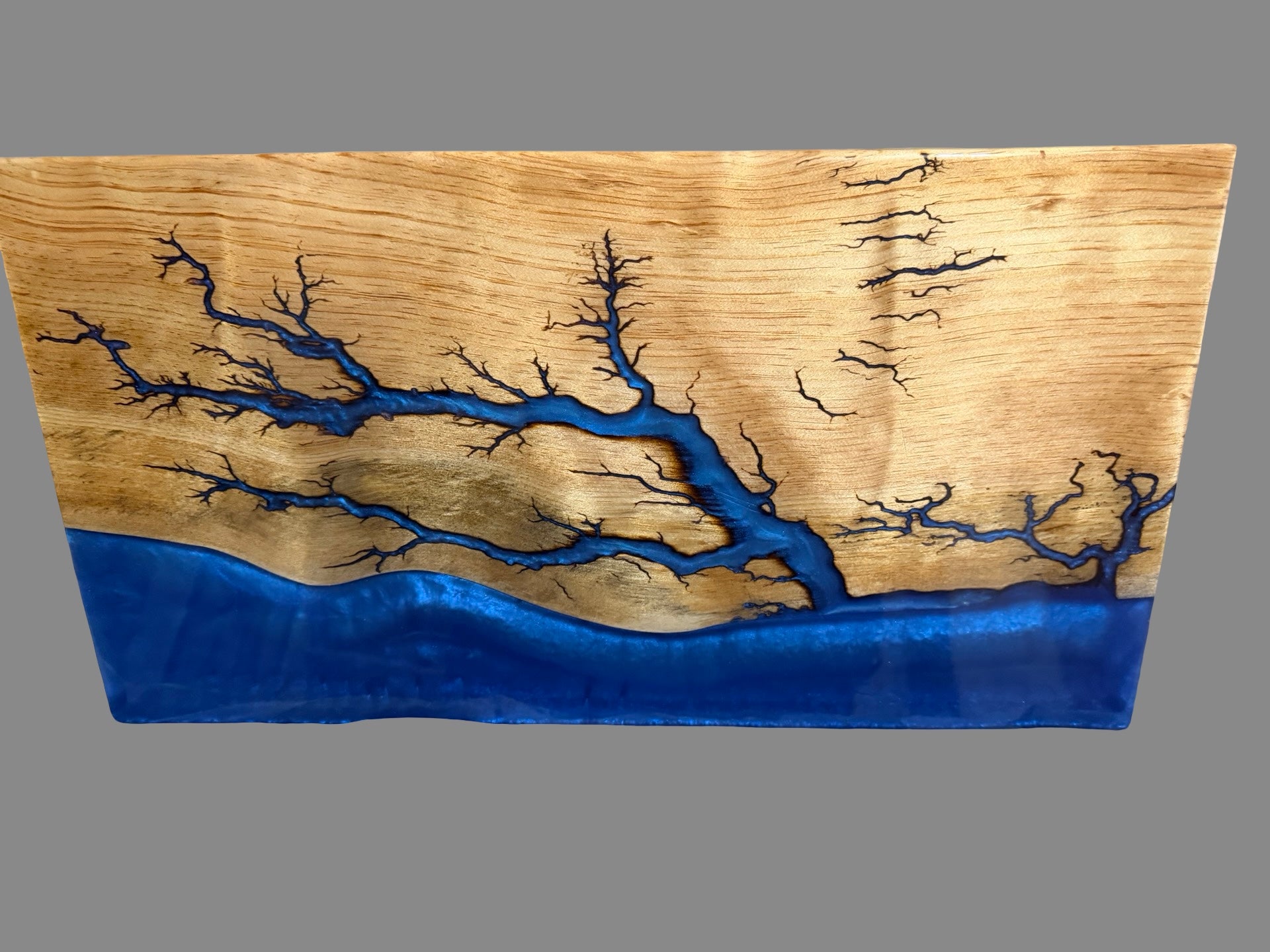 Premium resin serving board handcrafted from natural timber featuring electric blue resin and lightning-inspired fractal burning artwork, 580 x 300 x 30mm, perfect for serving cheese, antipasto and grazing spreads 