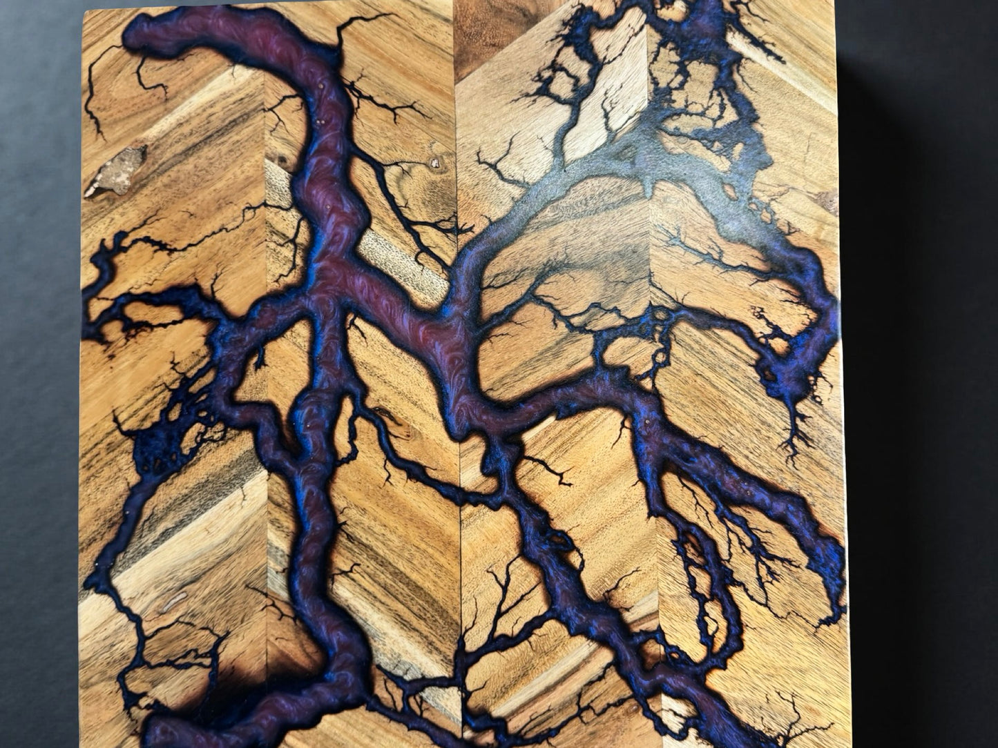 Square 320 x 320 chopping board from Bairnsdale Australia featuring a swirling red green chameleon resin layer with branching fractal burning art created by Fractal Flow Designs Australia’s resin board brand using premium Australian timber grain