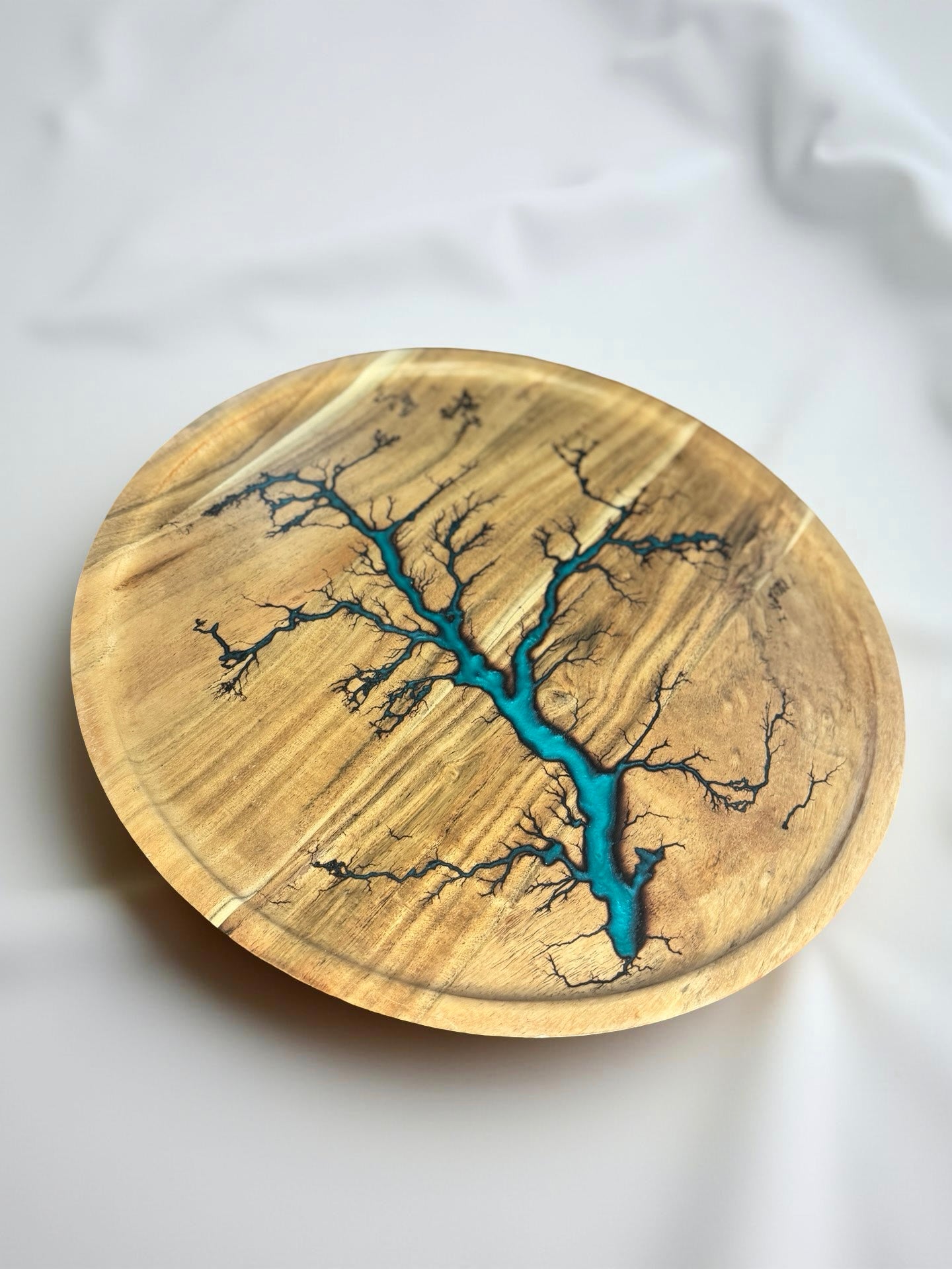 Teal round resin tray in motion Australian resin boards East Gippsland artisan craft